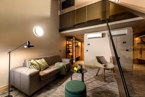 a living room with a couch and a chair at Hotel Terme Jezercica in Donja Stubica