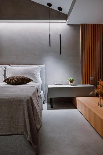 a bedroom with a bed and a bathtub and a table at Hotel Stomorin-Marina Hramina in Murter