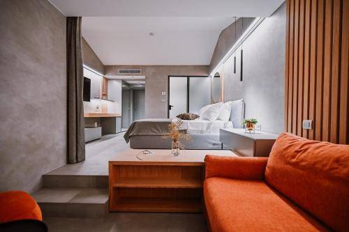a living room with a bed and a couch at Hotel Stomorin-Marina Hramina in Murter