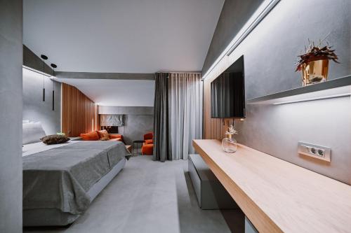 a bedroom with a bed and a desk in a room at Hotel Stomorin-Marina Hramina in Murter