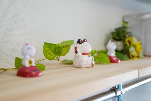a group of toy figurines sitting on a shelf at Kameari 1108 Budget Stay High Floor Near Station Mall Disney Access in Tokyo
