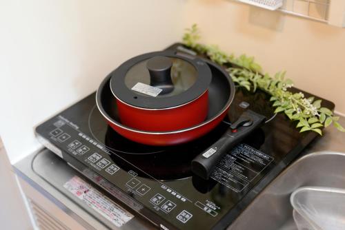 a stove top with two bowls on top of a counter at Kameari 1108 Budget Stay High Floor Near Station Mall Disney Access in Tokyo