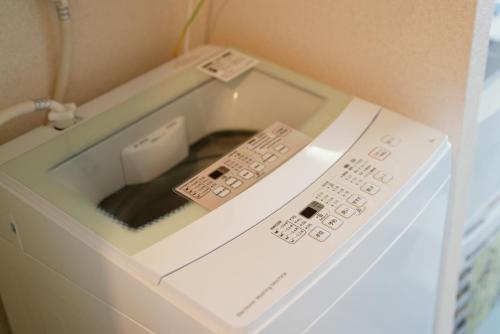 a microwave oven with a window on top of it at Kameari 1108 Budget Stay High Floor Near Station Mall Disney Access in Tokyo