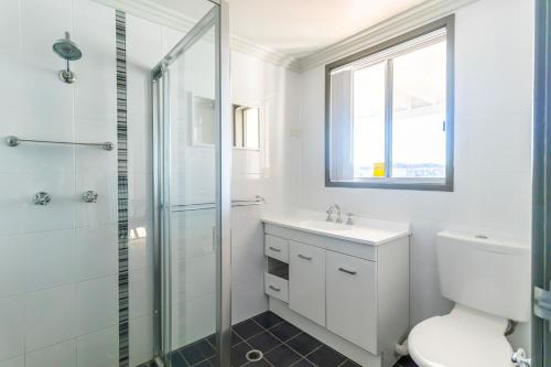 a bathroom with a toilet sink and a shower at Cockatoo House in Sussex inlet