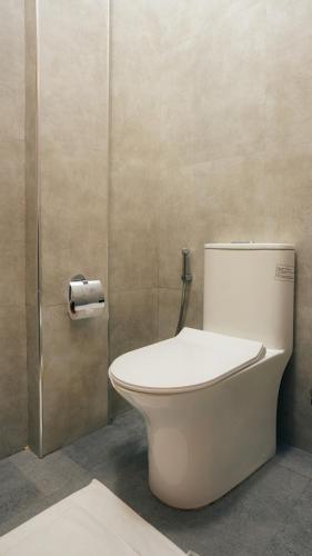 a bathroom with a toilet in a stall at Savera Beach Houses in Jambiani
