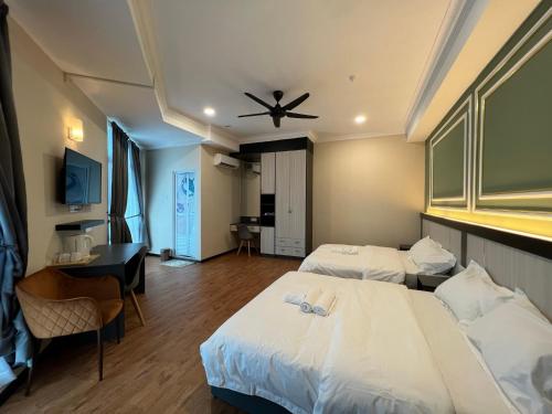 a hotel room with two beds and a ceiling fan at Dey Hotel Kota Bharu in Kota Bharu