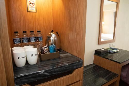 a shelf with a bunch of drinks in a hotel room at F Hotel Jian in Jian