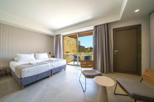 Habitación de hotel con cama y balcón en ISKIOS Premium en Agia Marina Nea Kydonias