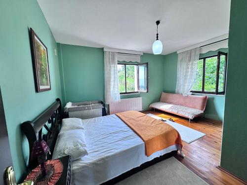 a bedroom with a bed and a couch at Beautiful Villa near the airport & city in Trabzon
