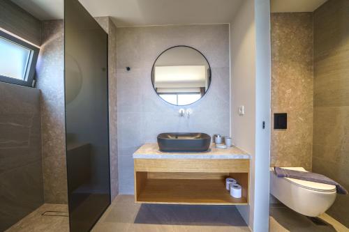 a bathroom with a sink and a mirror at ISKIOS Premium in Agia Marina Nea Kydonias