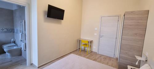 Zimmer mit einem Bad mit einem Spiegel und einem TV. in der Unterkunft Happy b&b in Torre Maggiore
