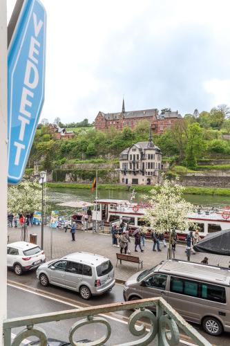a group of cars parked in a parking lot at Le Cerf Vert in Dinant