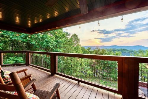a screened in porch with a view of the mountains at Panorama Mountain View Cabin, Less than 10 miles from Gatlinburg and Dollywood, Dog Friendly, 6 Bedrooms Sleeps 17, Fire Pit, HotTub, Washer Dryer, Fully loaded Kitchen, GameRoom with a TV, Pool Table, Arcade, Air Hockey, and Foosball in Sevierville