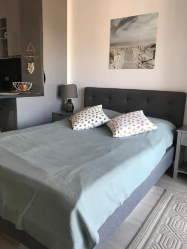 a bed with two pillows on it in a bedroom at Cosy studio apartment in Budva with sea view in Budva