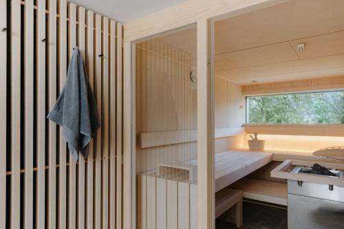 a small kitchen with wooden walls and a window at Benedikta,das Montafonerhaus in Vandans