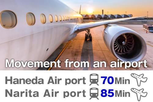an airplane parked on the tarmac at an airport at Kameari 1108 Budget Stay High Floor Near Station Mall Disney Access in Tokyo