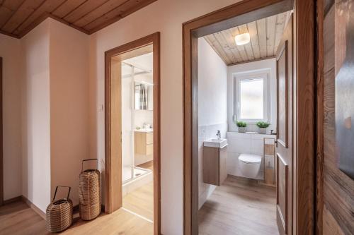 a bathroom with a toilet and a sink at Apartment Eve in Söll