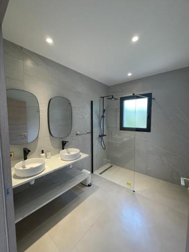 a bathroom with two sinks and two mirrors at Casetta Conca in Conca