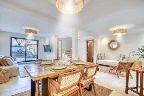 a dining room and living room with a table and chairs at Villa Bali Cocoon - Piscine - luxe - 4 or 5 Px in Agadir