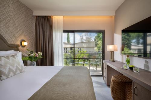 a hotel room with a bed and a balcony at Ayala by Isrotel Collection in Ayelet HaShahar