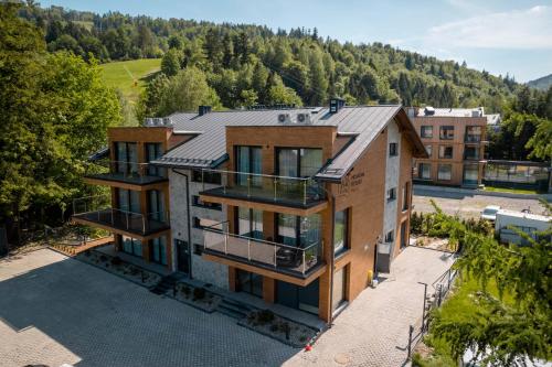 an aerial view of a house with a mountain at Apartamenty Pod Gondolą - Mountain Resort Villa - Dream Apart in Szczyrk
