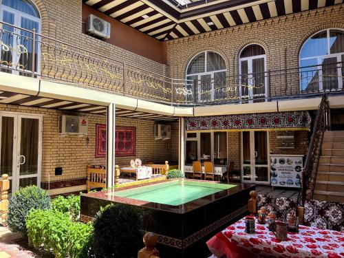 a house with a swimming pool in the courtyard at SHAHNOZA GRAND in Samarkand