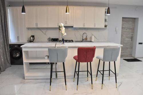 a kitchen with three chairs and a kitchen island at Apartment in Erebuni in Yerevan
