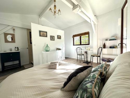 a bedroom with a large bed and a table at Chambre d'hôtes Cabanon à 10 min d'Aix-en-Provence in Aix-en-Provence