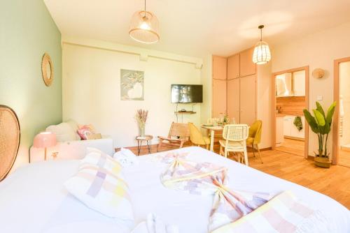 a bedroom with a bed and a living room at Centre - L'escale - Petite France in Strasbourg