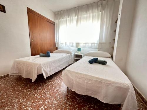 a room with two beds and a window at Puerto de Lo Pagan in San Pedro del Pinatar