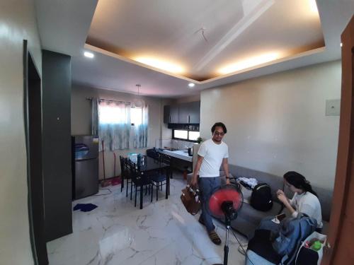 a group of people standing in a living room at Baverlly Home Stay in Cotabato