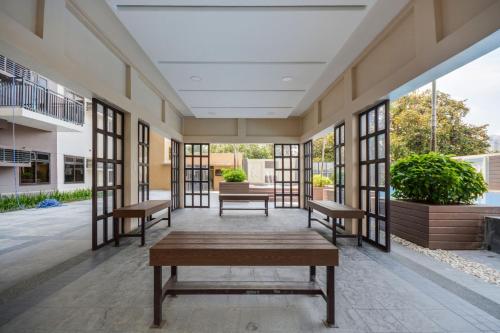 an empty lobby of a building with benches and windows at 1BEDROOM CONDO AZALEA WITH FREE WIFI in Tabok