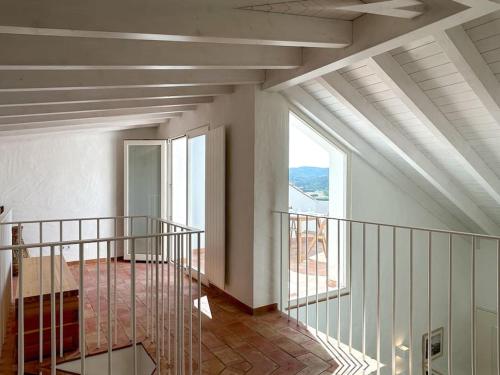 a room with a staircase with a large window at Casa das Piteiras nº3 - Aljezur in Aljezur
