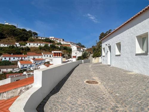 a balcony of a house with a view of a town at Casa das Piteiras nº3 - Aljezur in Aljezur