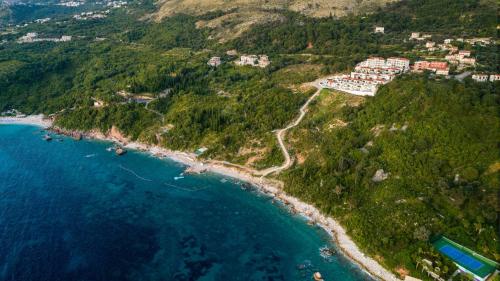 an aerial view of a resort on a hill next to the ocean at Signature Villa in Budva