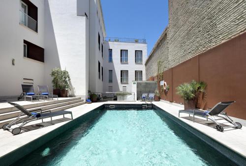 a swimming pool in the middle of a building at Eurostars Sevilla Boutique in Seville