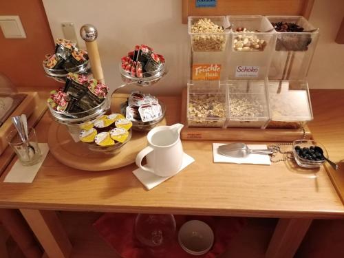 a table with a bunch of desserts on it at Hotel Garni Haus zum Gutenberg in Hallbergmoos