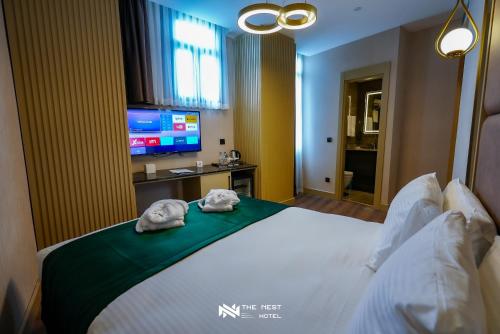 a hotel room with a bed with towels on it at THE NEST HOTEL in Istanbul