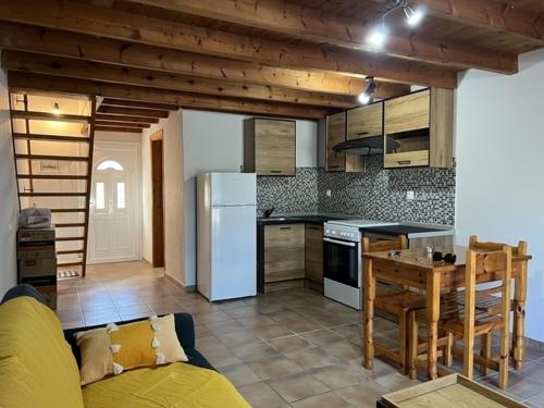 a kitchen with a couch and a table in a room at Harmony House Corfu in Kynopiástai