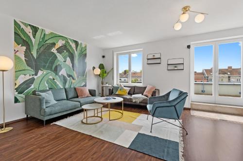 a living room with a couch and a table at Arbio I Premium Penthouse Apartment Augsburg in Augsburg