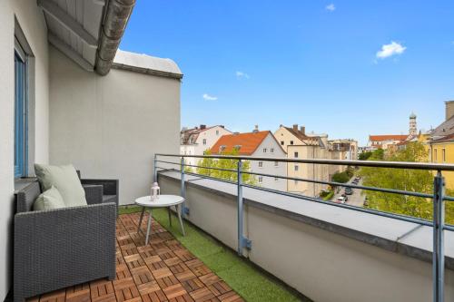 a balcony with a table and a view of a city at Arbio I Premium Penthouse Apartment Augsburg in Augsburg
