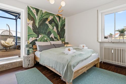 a bedroom with a bed with two towels on it at Arbio I Premium Penthouse Apartment Augsburg in Augsburg