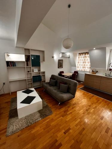 a living room with a couch and a table at VORTEX Apartment Skopje in Skopje