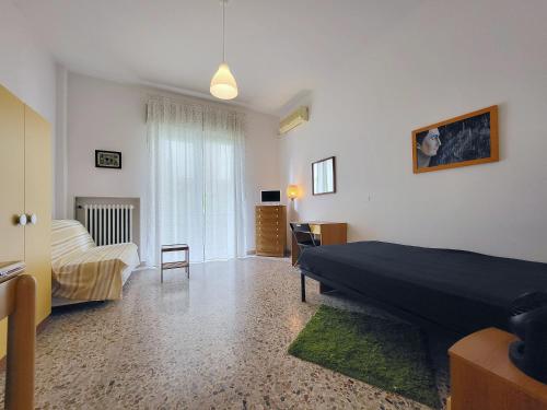 a large bedroom with a bed and a couch at Pochi passi dal mare in Pescara