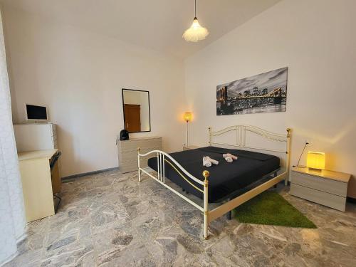 a bedroom with a bed with black sheets and a mirror at Pochi passi dal mare in Pescara