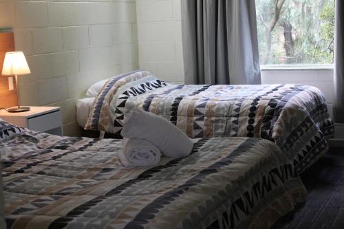 Ένα ή περισσότερα κρεβάτια σε δωμάτιο στο Coburg Motor Inn