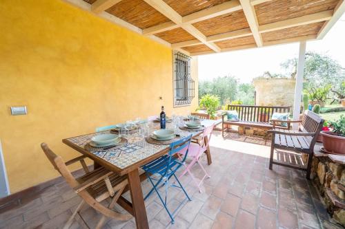 a dining room with a table and chairs on a patio at Appartamento il Poggino in Colle di Val d'Elsa