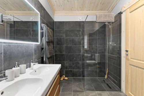 a bathroom with a sink and a shower at Croftner, Great Field Lodges in Braunton