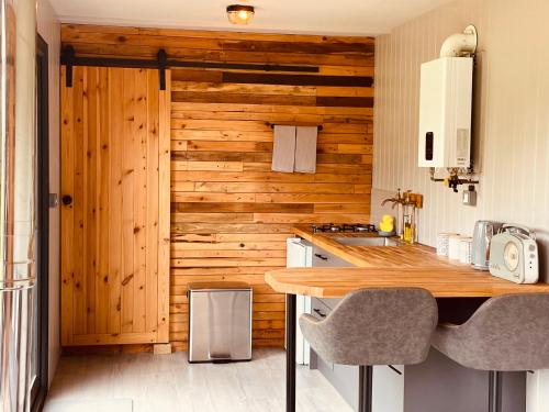 a kitchen with a wooden wall and a wooden counter at Casterton stays 