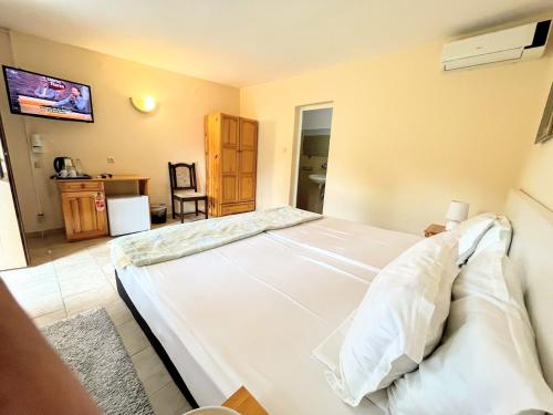 a bedroom with a large white bed in a room at Lotus Family Hotel - Free Parking in Sunny Beach
